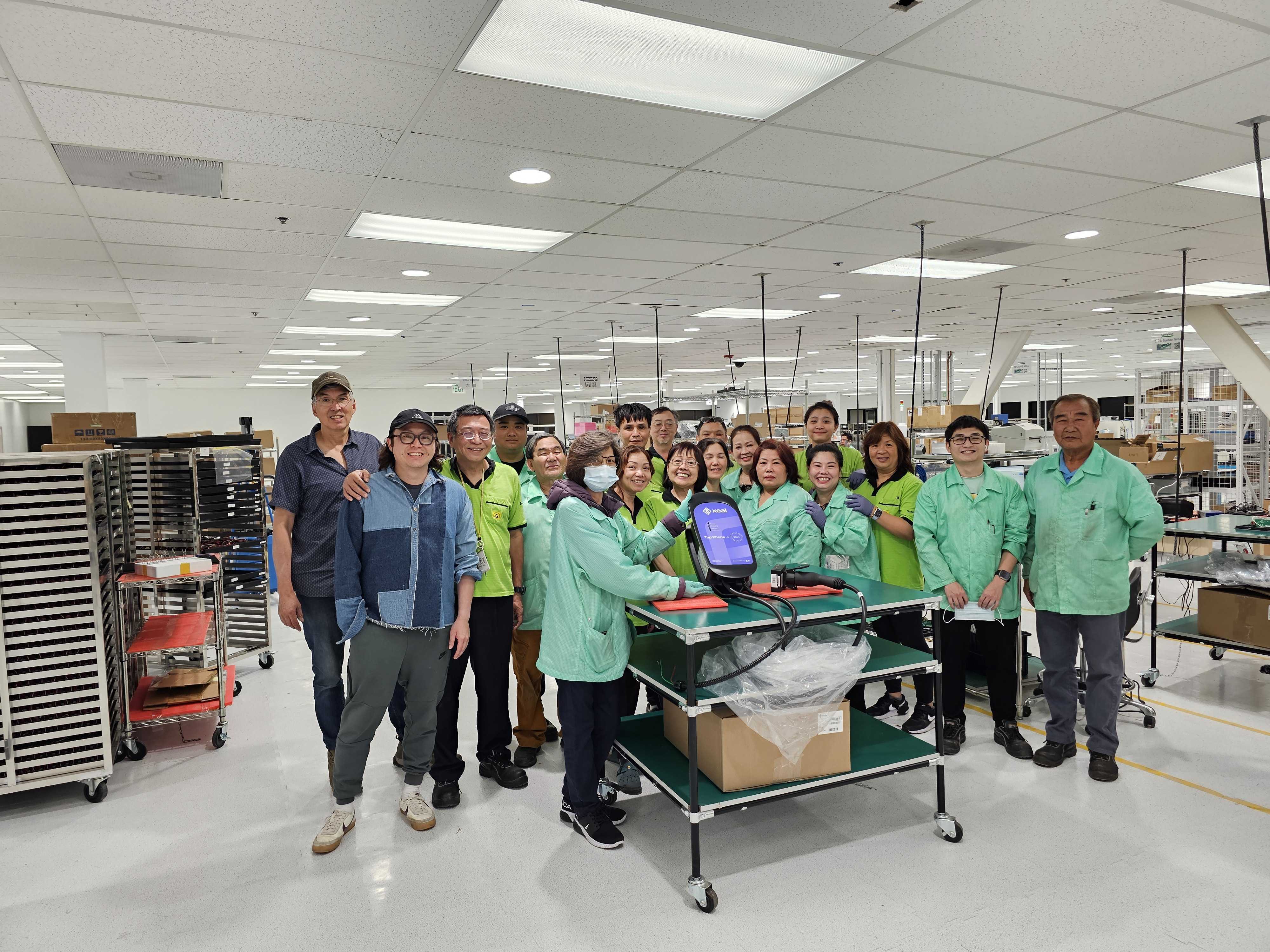 The manufacturing line team with a Xeal charger