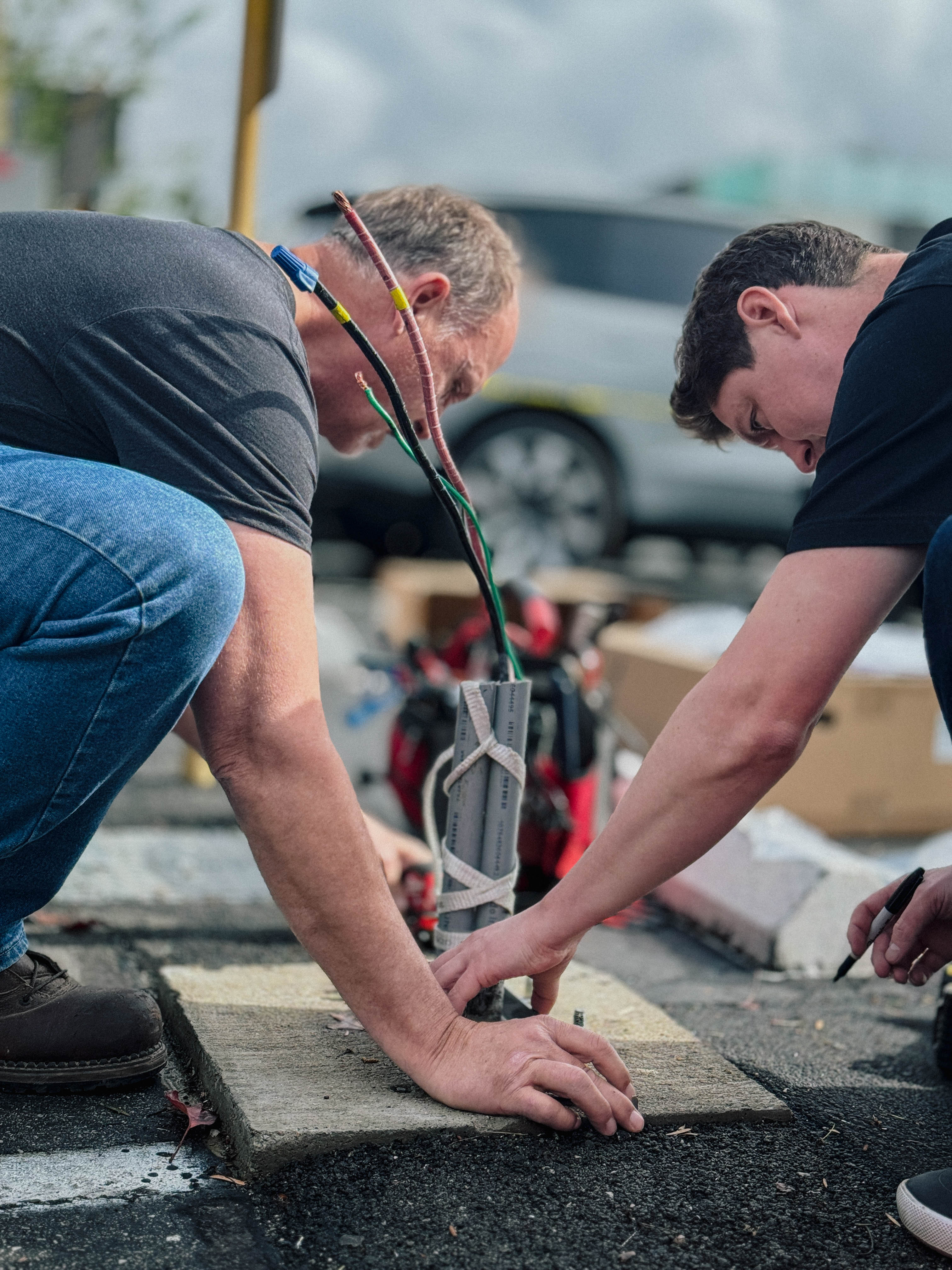 Technicians setting a charger foundation