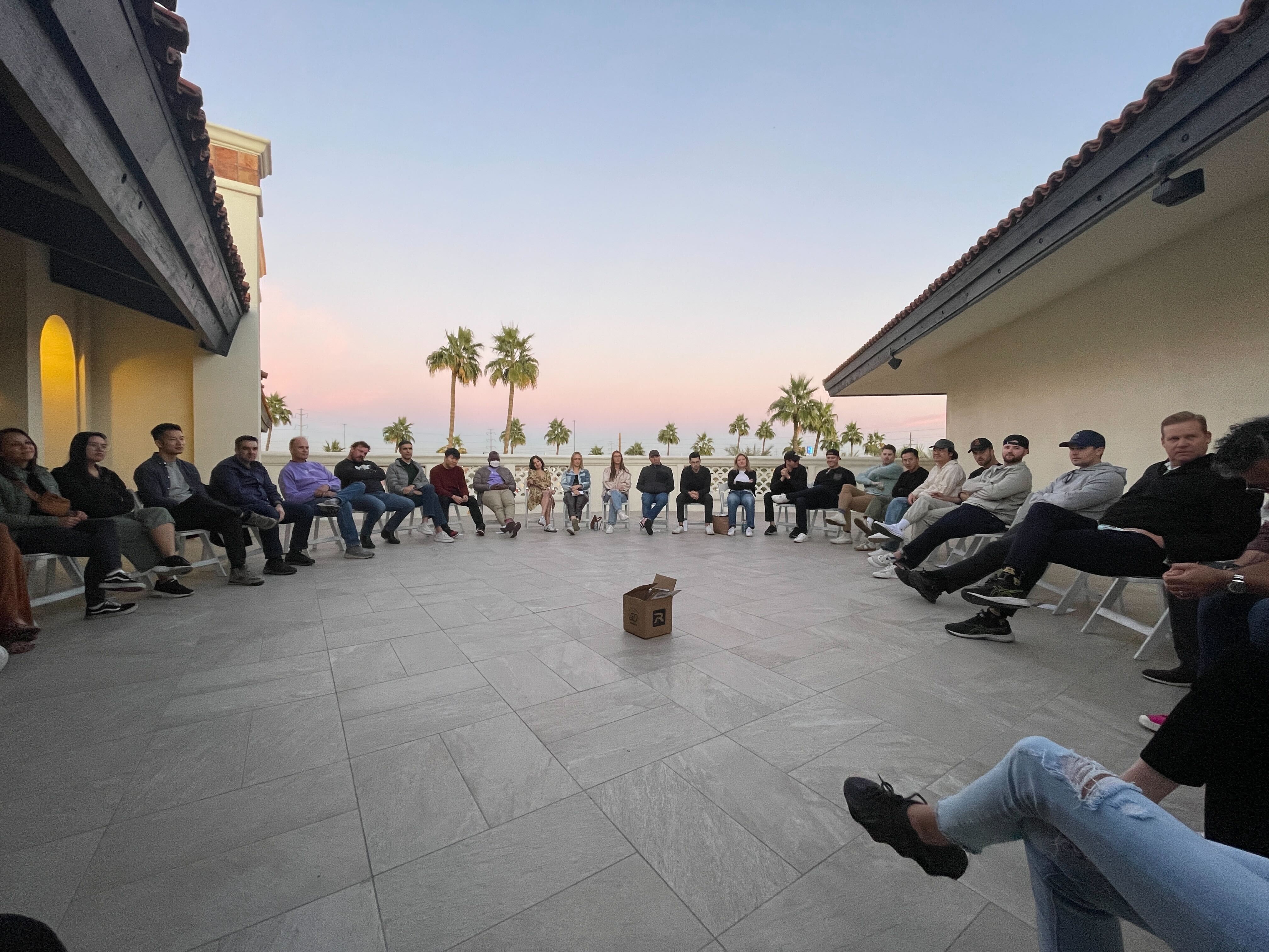 The team gathered in a circle at sunset